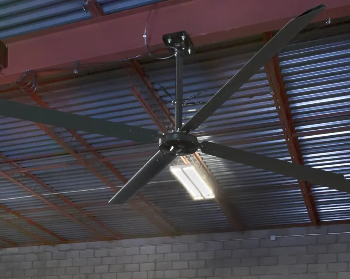 Hunter Industrial ECO HVLS fan mounted to corrugated metal roof in industrial facility